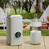 Portable water filter and bottle on a table with a picnic setup in the background