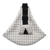 Houndstooth patterned sling bag with a black strap on a white background