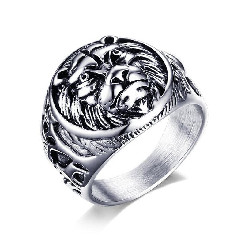 Silver ring with intricate design on a white background