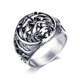 Silver ring with intricate design on a white background
