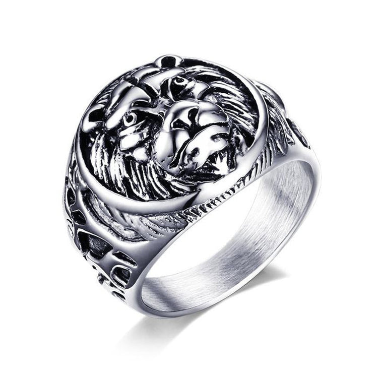 Silver ring with intricate design on a white background