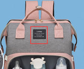 Gray backpack with pink straps and a visible brand label on a blue background
