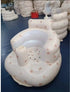Inflatable baby seat with floral pattern on a blue surface