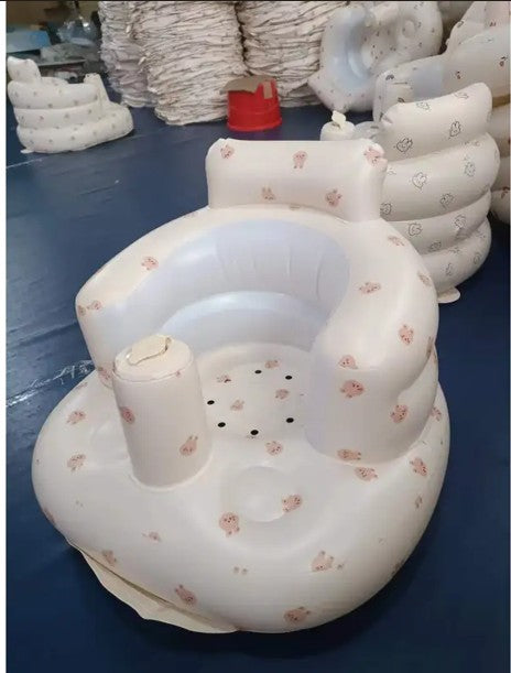 Inflatable baby seat with floral pattern on a blue surface