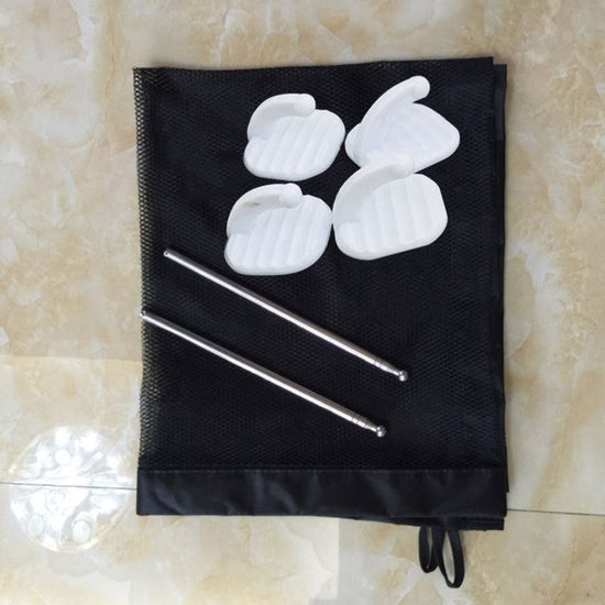 Black mesh bag with white silicone molds and metal rods on a beige tiled floor.