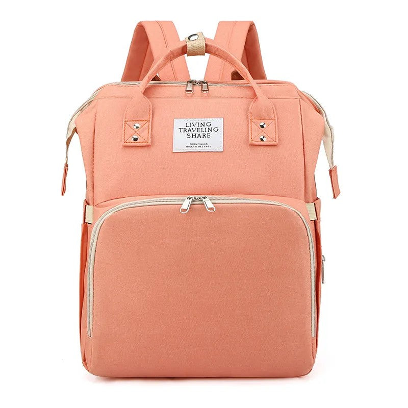Peach-colored backpack with gold accents on a white background