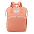 Peach-colored backpack with gold accents on a white background