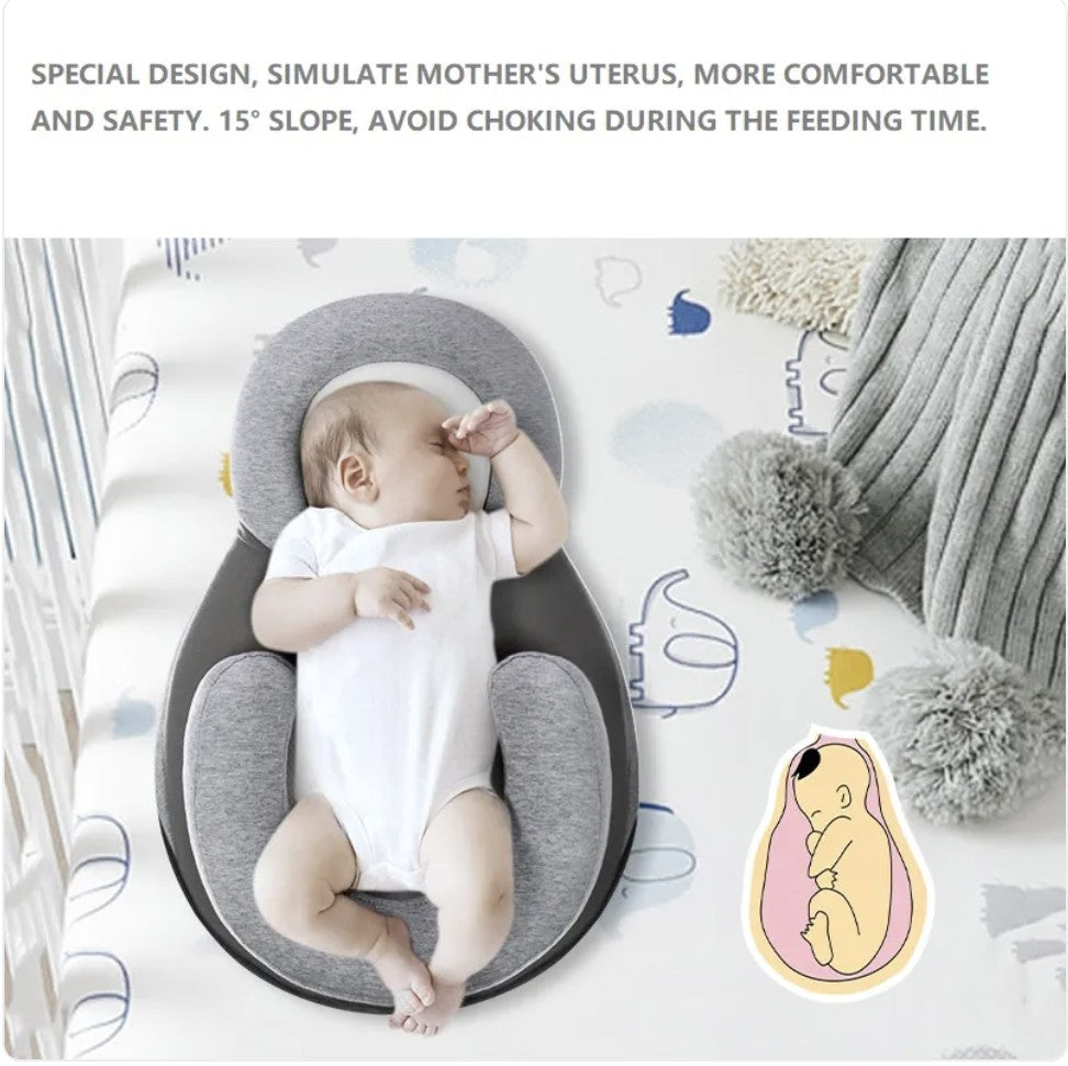 Baby lying in a gray and white baby nest with text about its design and safety features.