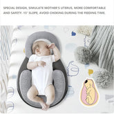 Baby lying in a gray and white baby nest with text about its design and safety features.