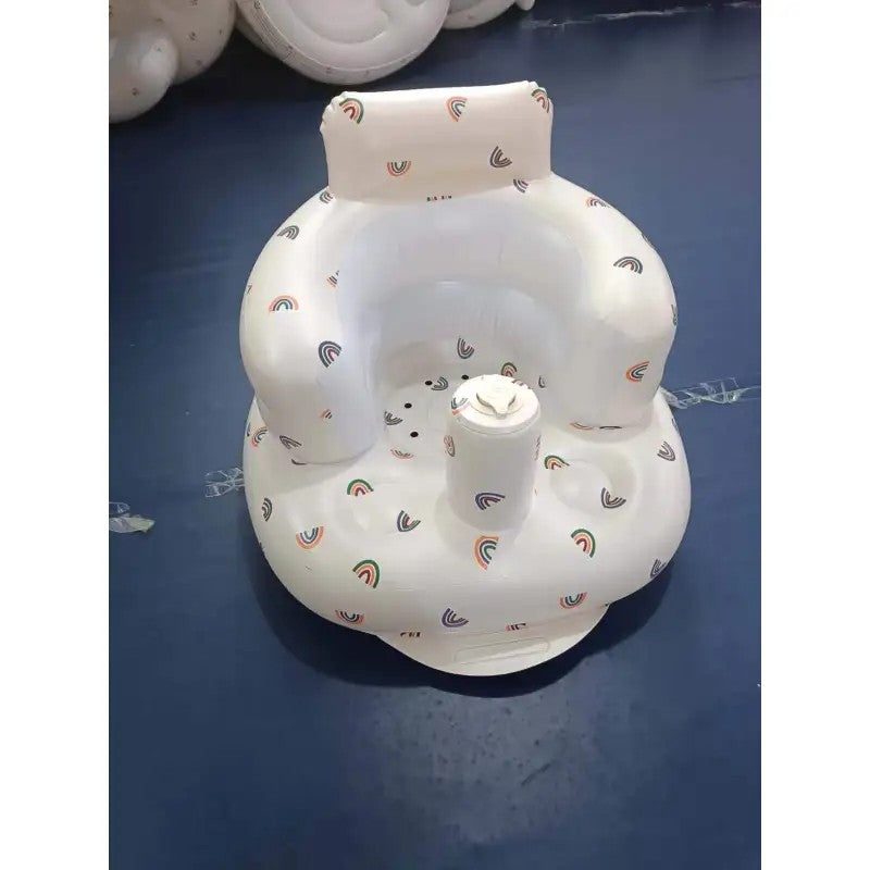 Inflatable baby seat with rainbow pattern on a dark surface