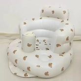 White inflatable baby seat with bear pattern on a white background