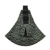Leopard print dog muzzle with black straps on a green background